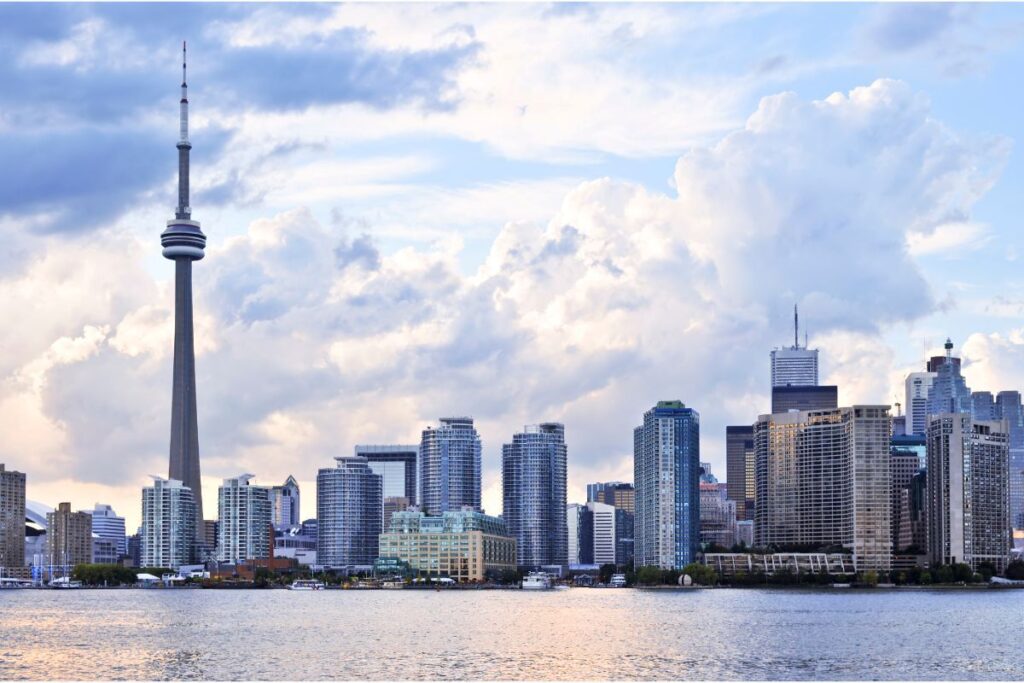 Corporate skyline in Toronto, with cloudy blue sky behind